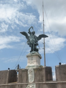 St. Michael the Archangel atop the fortress, sheathing his sword, to show the end of the plague.
